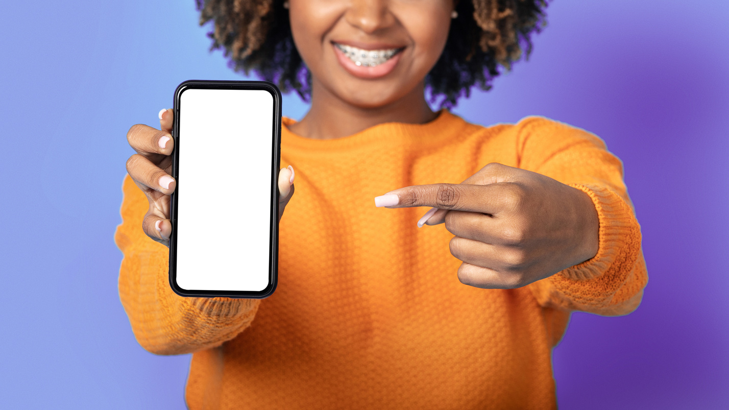 Cell phone with empty screen in female hands, mockup